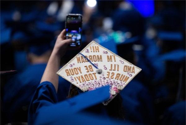 The back of a graduate&rsquo;s hat at the Fall 2023 commencement ceremony that reads &宝贝,你好! I&rsquo;m Morgan and I&rsquo;ll be your nurse today!&”,