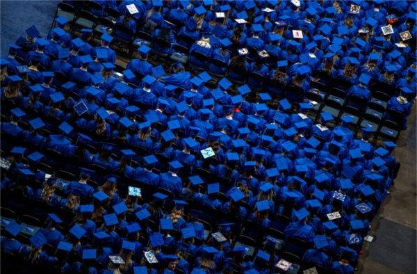 Graduates sit at Van Andel arena during the fall 2023 commencement ceremony.